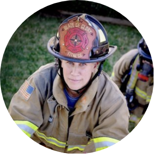 Shay Mountford climbing a ladder in her firefighter gear.