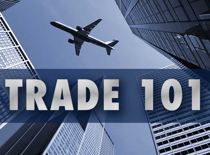 plane over buildings and words Trade 101