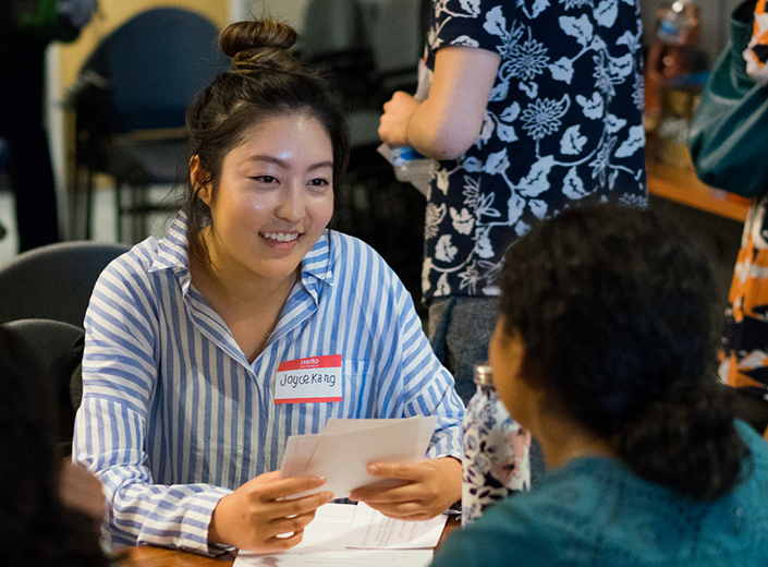 Asian-American female student works on interviewing at college event.