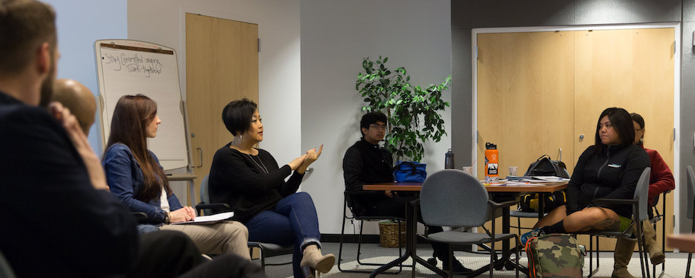 Students and faculty discuss issues at a college event.