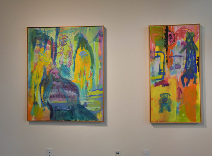 Two colorful paintings by Don Shields on a white gallery wall.